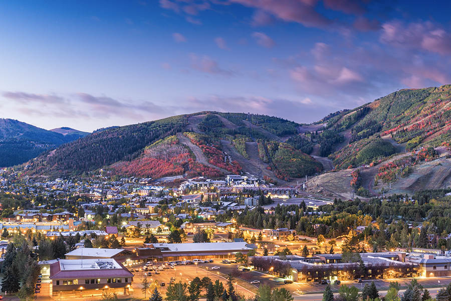 SentryWest Insurance - Park City UT Insurance - Beautiful Birds Eye View Of Park City Utah At Dawn With Purple Skys and Glowing Lights